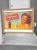 Framed vintage Dr. Pepper advertising sign featuring actress Ruth Valmy, showing overall front and frame.