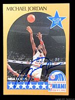 Front of card showing Michael Jordan shooting with All-Star East logo, NBA Hoops logo, All-Star Weekend Miami Feb. 9-11, 1990, gold border, autograph across front.
