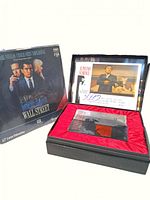 Photo of Wall Street laserdisc signed by actors on the cover, and Scarface memorabilia box open showing signed framed photo and sealed laserdisc inside red satin lining.