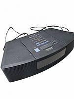 Front angled view of the black Bose radio with top control panel and speakers on each side.