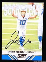 Front of signed 2021 Panini Score Justin Herbert football card showing player image, autograph, and branding.