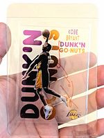 Front view showing Kobe Bryant dunk graphic, purple and gold “Dunk'N Go-Nuts” text and red ink signature