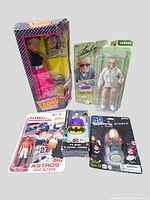 Lot of assorted figurines including Ebony doll, Stan Lee action figure, Houston Astros Jose Altuve baseball figurine, DC Joker figure, and Rolling Stones bobblehead