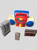 All four items displayed: Plaskool boombox, Sony Walkman FM, Toshiba FM tuner pack, metal transistor radio
