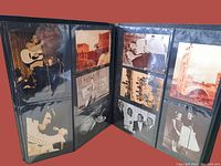Photo showing a selection of postcards in protective sleeves including a man playing guitar and various vintage images of celebrities and Las Vegas scenes.