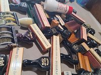 Multiple wooden handled ink stampers showing printed company names and official inscriptions on rubber labels, laid out on a flat surface.