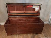 Open view of the cedar chest showcasing cedar lining and inner shelf compartments.