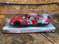 Model car displayed inside original plastic case on branded cardboard base.