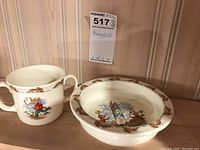 Photo showing the handled children's cup with Bunnykins design and a shallow bowl with Bunnykins illustration and brown bunny border.