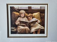 Close-up of the print showing two girls reading a book, highlighting the image details and colors.