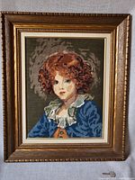 Full front view of vintage rughook art framed in ornate wooden frame showing the full image of the Jeune Garcon portrait.
