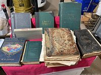 Overview of all books laid on a table showing various sizes, conditions and covers