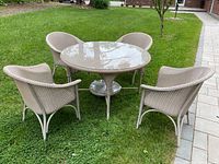 Overview of the dining set with round table and four chairs arranged outdoors