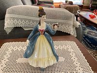Front view of Royal Doulton Leading Lady figurine showing detailed dress and figure holding compact mirror.