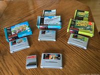 Four Super Nintendo game cartridges with original boxes and instruction booklet for Pilotwings, plus one smaller cartridge for Game Hunter Pro CD version.