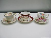 All three Aynsley vintage teacups and saucers shown side by side