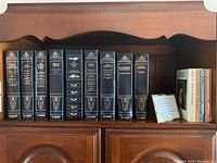 Full shelf view of the classic literature books collection in decorative black bindings with gold embossing.