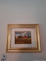 Front view of framed original double sided painting depicting autumn trees and wheat field