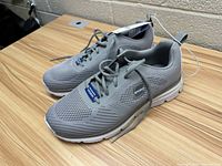 Side angle close-up of the men's Skechers gray athletic shoes showing mesh design and outsole tread.