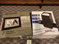 Photo showing both Pandigital digital photo frame and VuPoint film scanner in their original boxes.