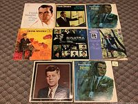 Top view of 8 Frank Sinatra vinyl records with various distinct covers showing photos, paintings, and illustrations of Sinatra.