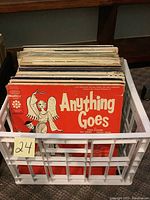 Vinyl albums in a plastic crate with the front visible showing the 'Anything Goes' album cover.