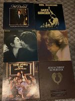 Overview photo of all six vinyl album covers showing condition and variety in the lot.