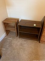 Two wood bookcases positioned adjacent to each other, showing size and condition including scratches.