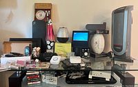 Full view of the tabletop with all main items visible including the Lasko heater, lava lamp, diffuser, football, sleep sound machine and several small electronics.