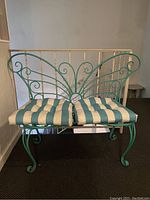 Front view of bench with striped cushion in place