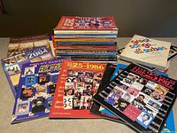 Overall view of the collection of colorful music publications stacked in three groups on a flat surface.