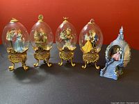 Front view of all five Disney eggs with the castle-shaped egg holder.