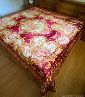 Bedspread fully spread on bed showing overall design and colors