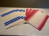 Overall view of both placemat sets on countertop, showing color and texture difference