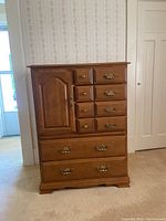 Full front view of the Vilas wooden chest of drawers showing drawers, cabinet door, and brass hardware