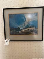 Front view of framed Emily Carr print showing blue sky, tree stumps, and landscape