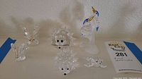 Image showing 5 Swarovski crystal figurines (2 hedgehogs, fish, dolphin, swan) and 1 frosted crystal hummingbird figurine
