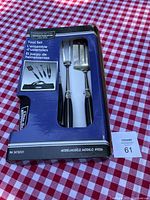 Blue and black box packaging showing the Char-Broil Commercial Series BBQ Tool Set with visible spatula, fork, and tongs handles.
