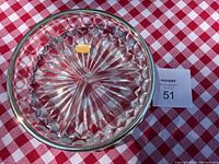 Top view of the round Bleikristall crystal serving dish showing three equal segments and a yellow label.