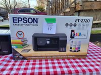 Box of Epson ET-2720 printer with product branding and features visible.