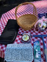 Photo showing basket, hand mirror in floral case, fabric pouch, and toothbrush case