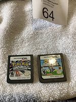 Both Nintendo DS cartridges shown side by side on white textured surface.