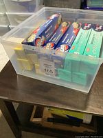 Plastic container with 4 rolls of unopened kitchen wraps and foils