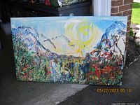 Front view of the large colorful landscape painting showcasing mountain, sun, and greenery.