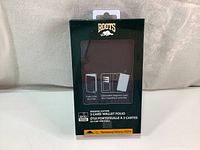 Front view of sealed Roots leather wallet folio packaging, black case visible inside, indicating designed for Samsung Galaxy S22+. Includes folio and detachable magnetic case with card slots.