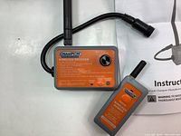 Close-up photo showing wireless receiver and remote control units with attached antennas and connection cable, detailed Champion branding and model information visible.