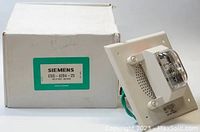 Photo of Siemens CSS-4204-25 unit with white box showing model label, wiring, and strobe light on side