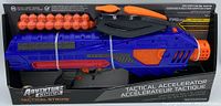 Photo showing the full boxed motorized ball blaster in blue and orange with orange foam balls included, tied in packaging.