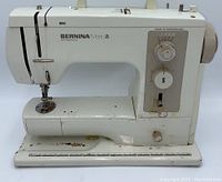 Front angle view showing overall condition with rust and wear spots on base and needle plate area.