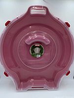 Top view of the wreath storage case showing the red base, clear cover, and handle